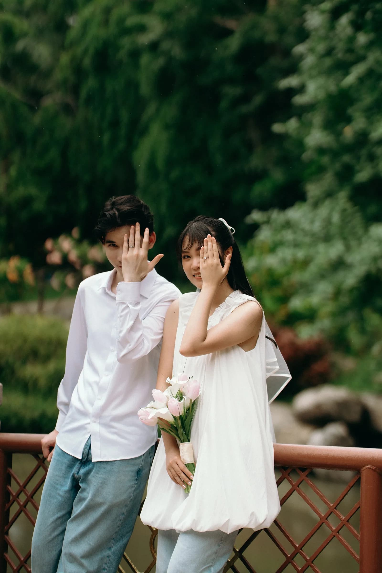 Natthida and Tanakan showing their engagement rings together